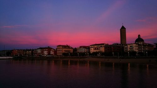 Buildings in city at sunset