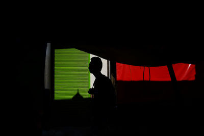 Silhouette man standing in corridor