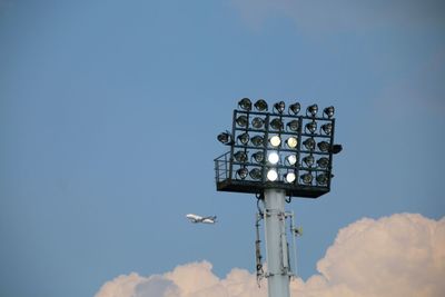 Low angle view of floodlight against sky