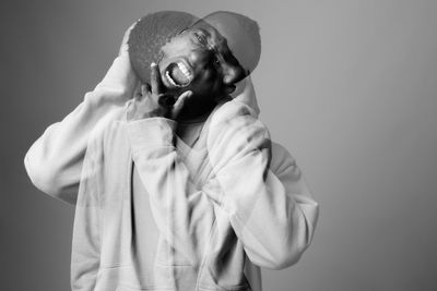 Portrait of person standing against white background