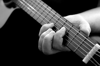Cropped image of person playing guitar