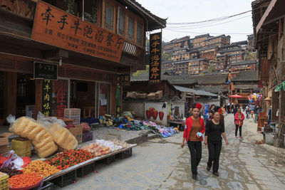 People at market stall in city