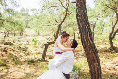 Couple holding hands on tree