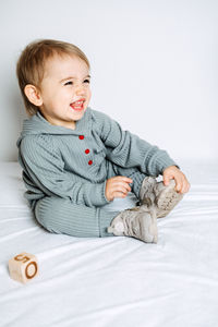 Unisex clothes for babies. cute baby in cotton set suit on light background. kids fashion