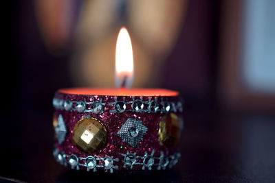 Close-up of illuminated candles on table