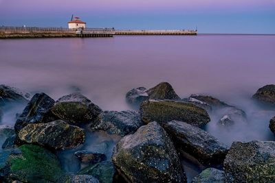 Scenic view of sea against sky at dusk