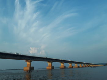Low angle view of bridge over sea against sky