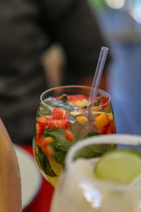 Close-up of drink with fruit and mint served on table