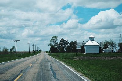 Empty road against cloudy sky