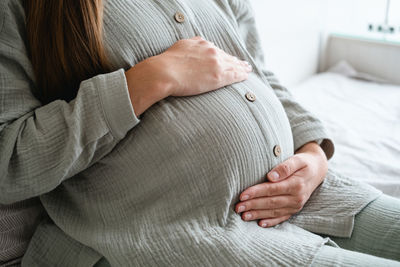 Midsection of woman with blanket