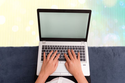 Low section of person using laptop on table