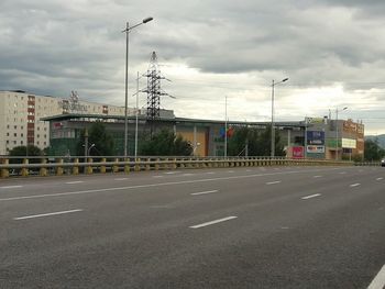 Road by city against sky