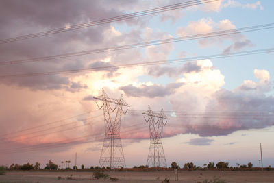 Electricity pylon against sky during sunset