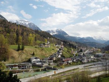 Scenic view of landscape and buildings against sky