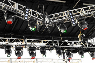 Spotlights and speakers mounting on stage by technician in lights and sound