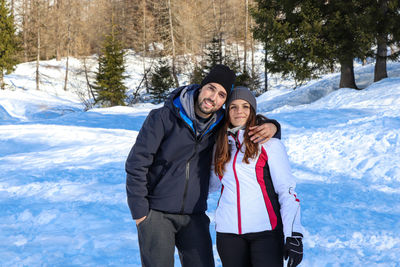 Two young people loving each other on snow covered land