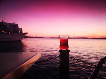 Boat on sea against sky during sunset