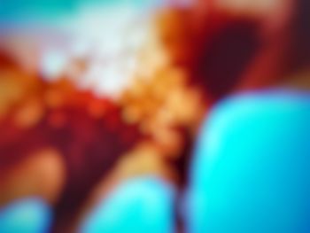 Defocused image of people on multi colored blurred background