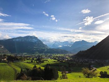 Scenic view of landscape and mountains against sky