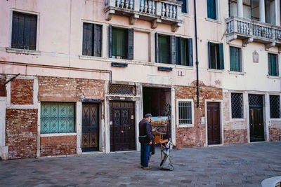 People on street against building in city