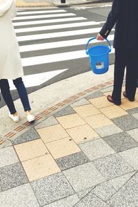 Low section of man walking on road