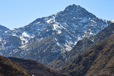 Scenic view of snowcapped mountains against clear sky