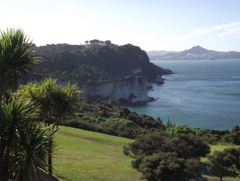 Scenic view of sea and mountains against sky