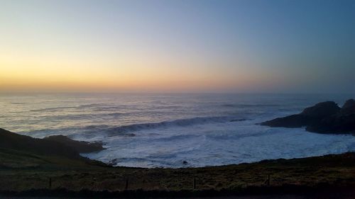 Scenic view of sea against clear sky during sunset