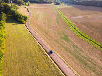 High angle view of agricultural field. aerial view of road. aerial view of a car on the road 