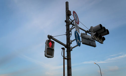 Low angle view of road signal against sky