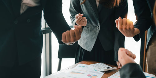 Midsection of business colleagues working in office