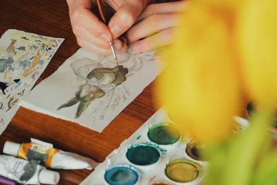 High angle view of woman painting on table