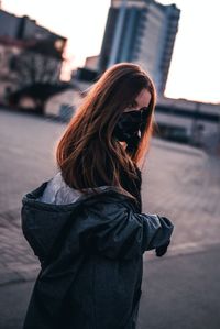 Midsection of woman standing in city