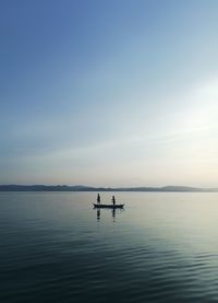 Silhouette boat in sea against sky during sunset