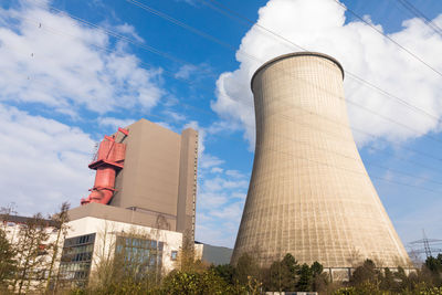 Low angle view of smoke stack against sky