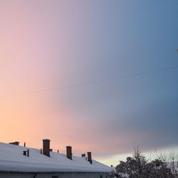 Low angle view of houses against sky during sunset