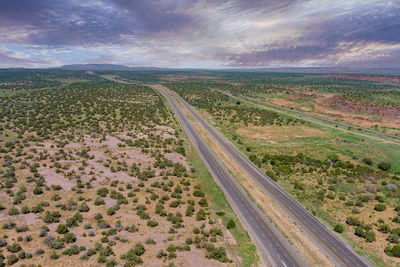 High angle view of road amidst land against sky