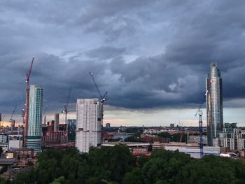 Cityscape against cloudy sky