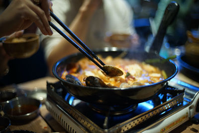 Close-up of person preparing food in kitchen