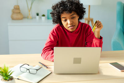 Young woman using laptop at office