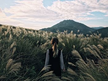 Man standing on landscape against sky