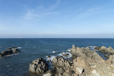 Scenic view of sea against blue sky