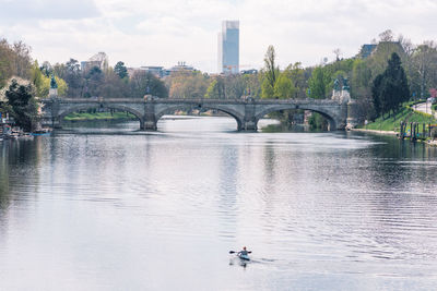 Beautiful aerial view of po river in torino, italy with buildings, skyscraper bridge and murazzi