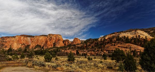 Scenic view of rocky mountains against cloudy sky