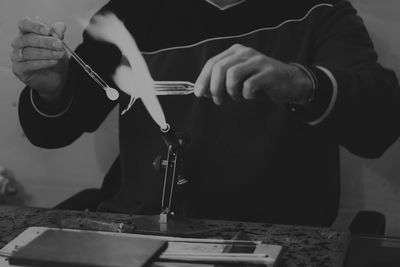 Cropped image of man holding machine part