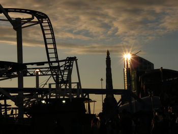 Silhouette of ferris wheel against sky during sunset