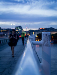 Man in illuminated city against sky