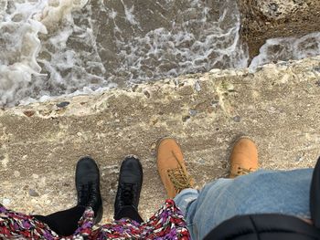 Low section of man and woman at beach