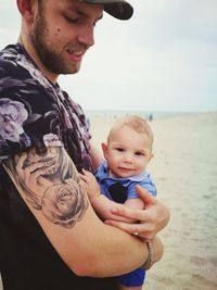 Portrait of happy father holding baby