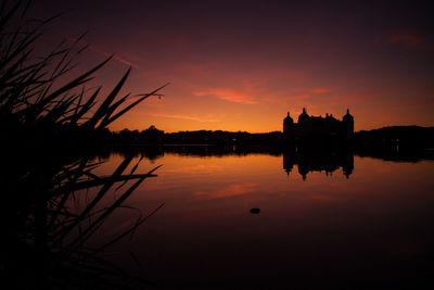 Scenic view of lake against romantic sky at sunset